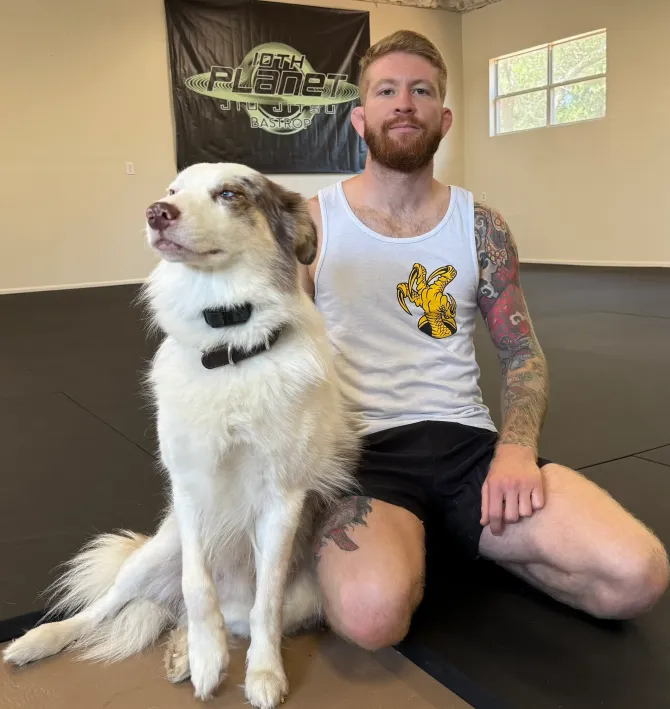 Gabe Tuttle at 10th Planet Bastrop with his dog inside the Brazilian Jiu-Jitsu academy