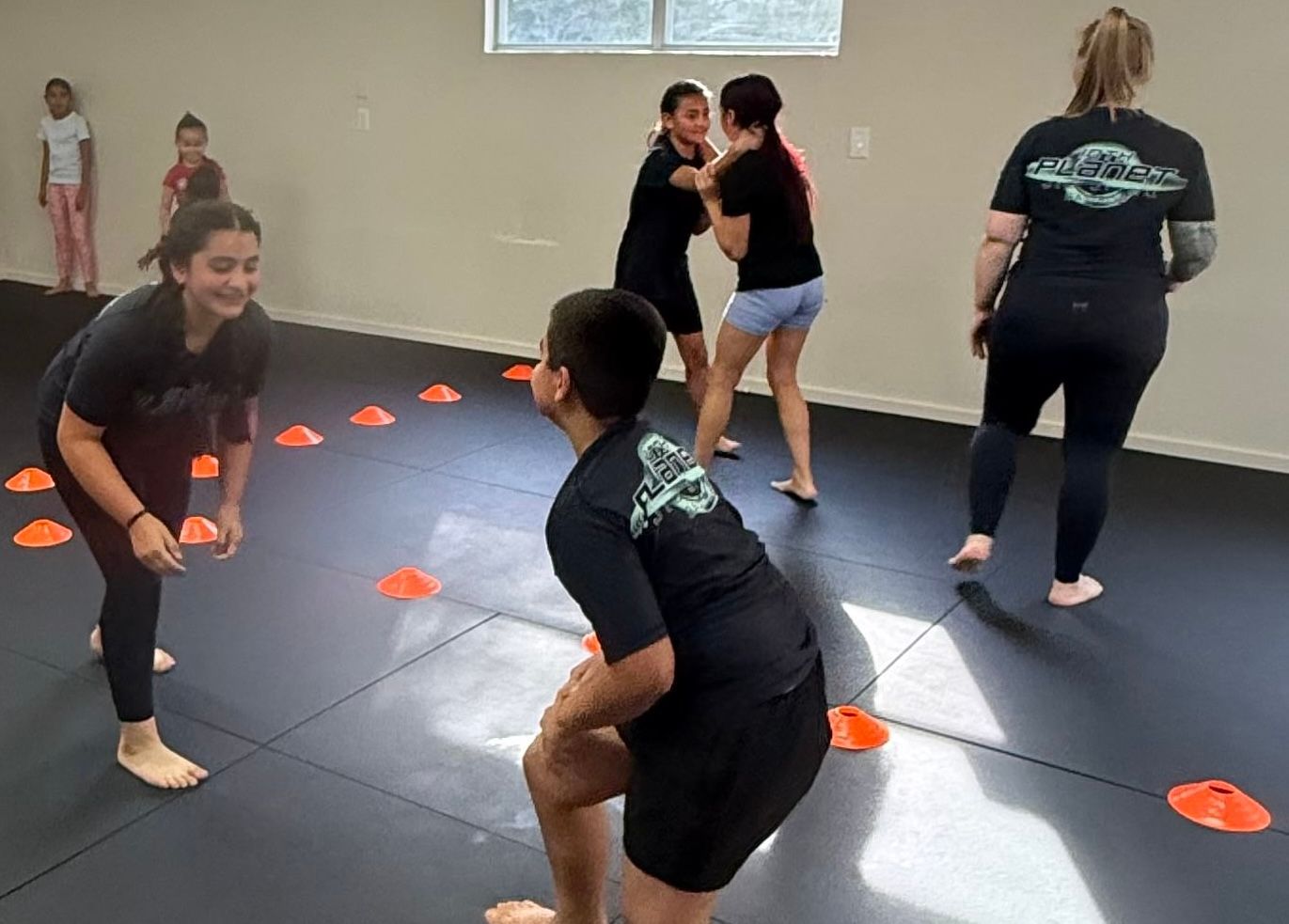 Children participating in a Brazilian Jiu-Jitsu class at 10th Planet Bastrop in Bastrop, Texas