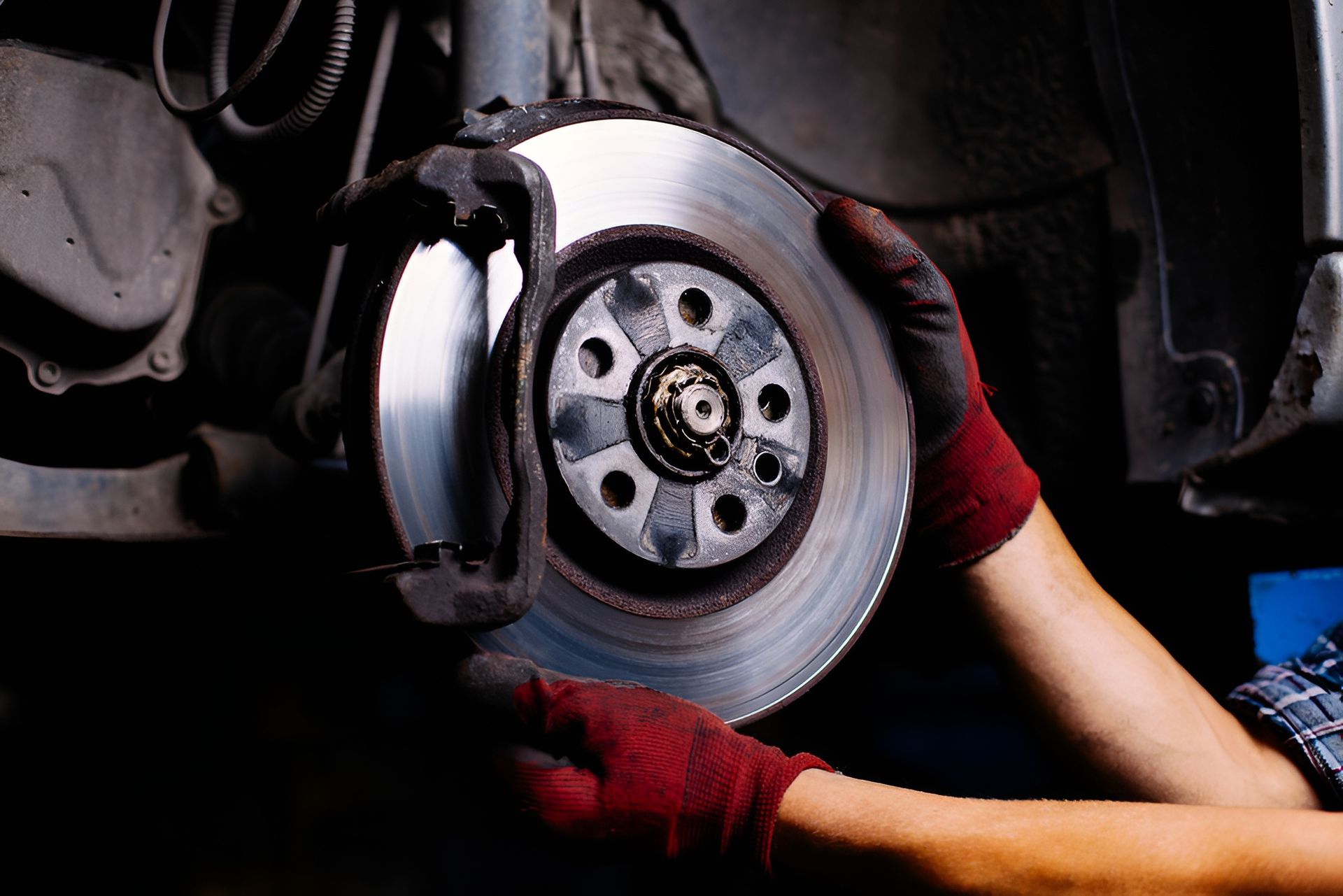Mechanic Holding a Car Brake Rotor in Front of the Vehicle — EFI Evolutions Mechanical Repairs in Grafton, NSW