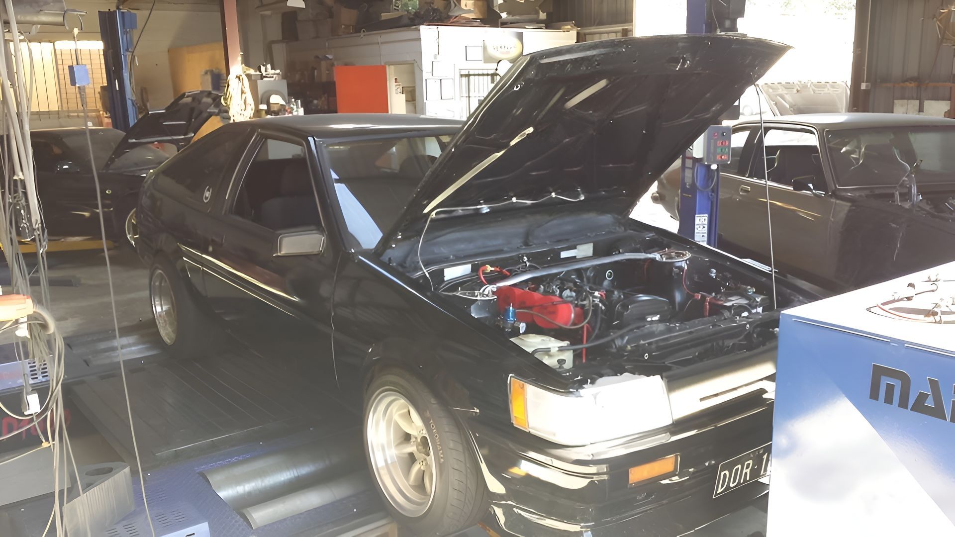 Black Toyota Ae86 With Hood Open in a Garage — EFI Evolutions Mechanical Repairs in Coffs Harbour, NSW