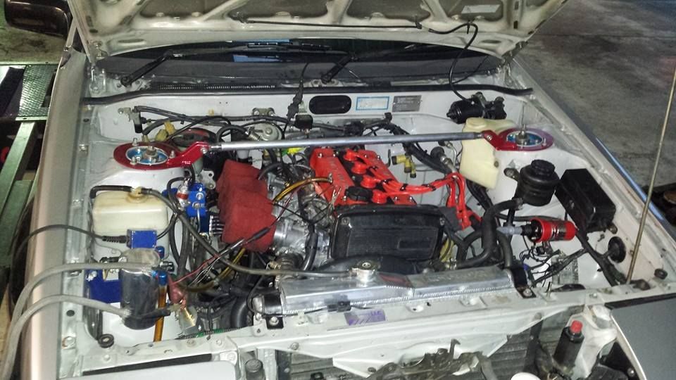 Engine Bay of a Silver Car With Modifications  — EFI Evolutions Mechanical Repairs in Coffs Harbour, NSW