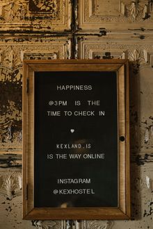 Black sign with white letters. Message: