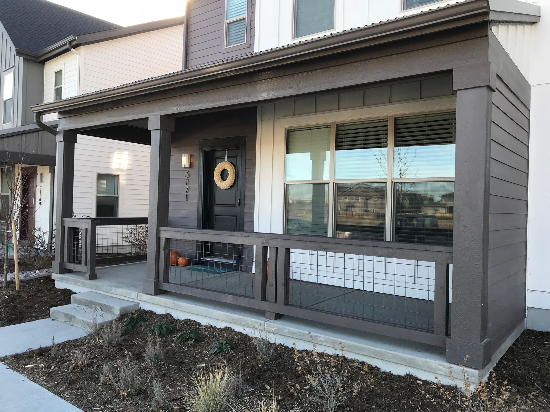 A house with a porch and a wreath on the door.