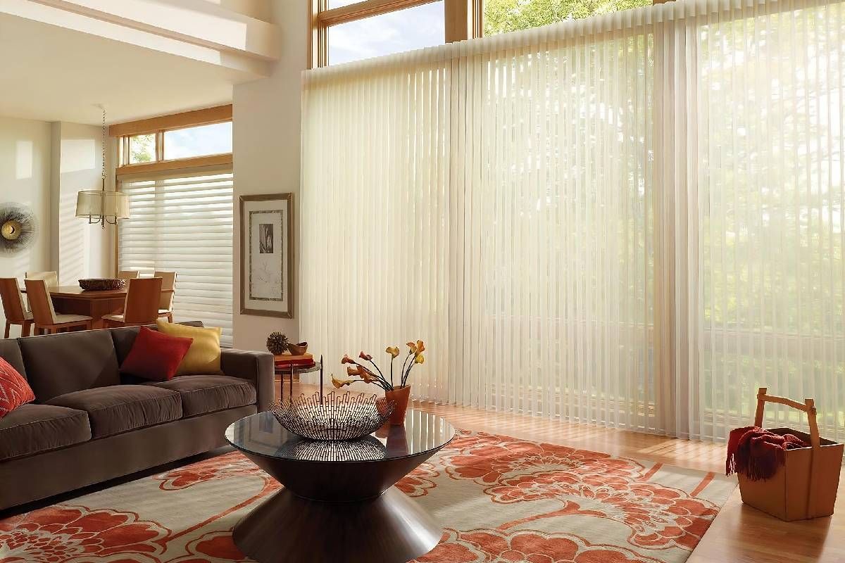 Elegant home interior with sliding windows covered by Hunter Douglas Luminette® Sheer Panels at Curtain Concepts near Huntington, WV