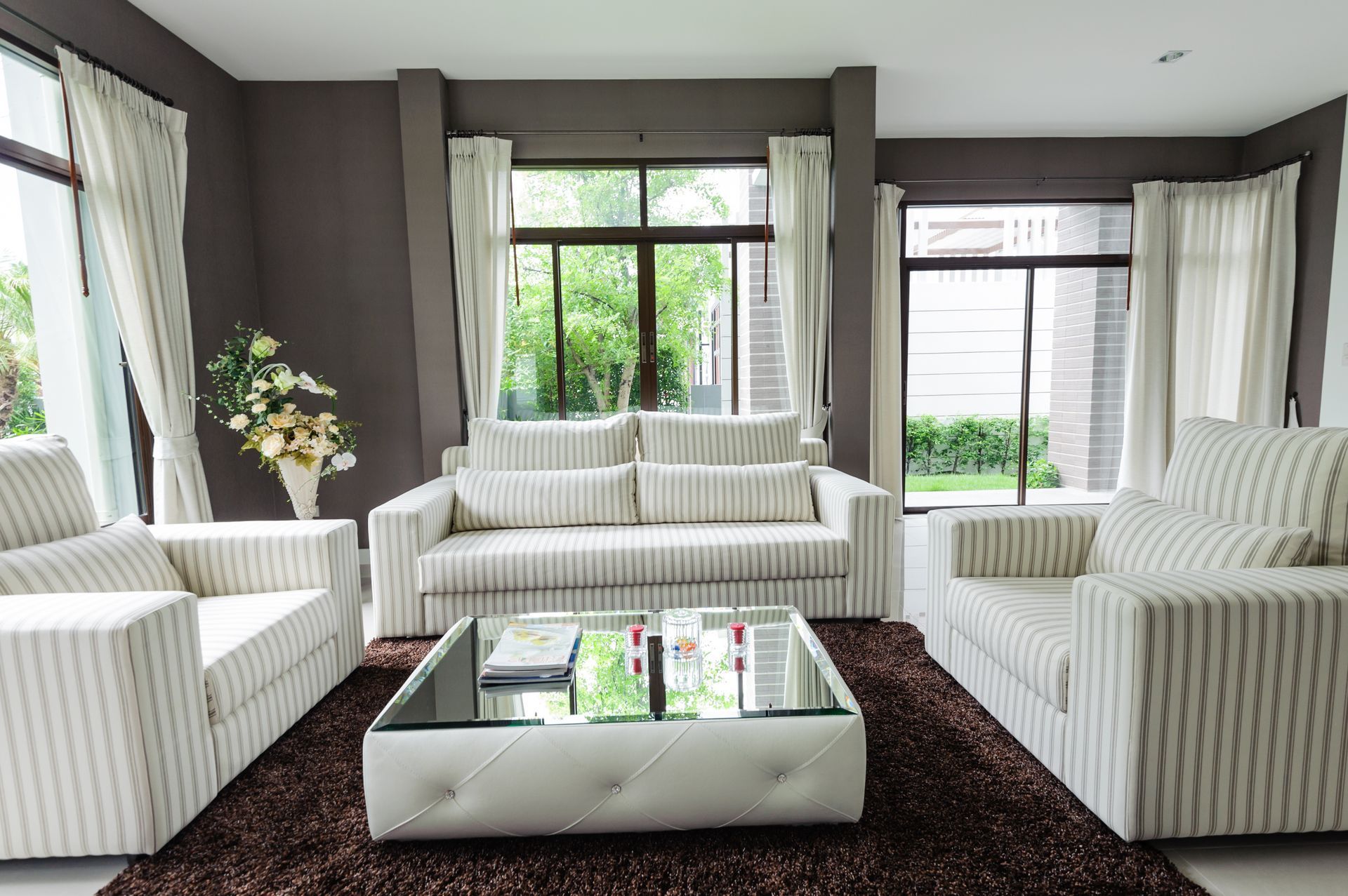Contemporary living room with custom drapes and corresponding hardware to other metals in the space