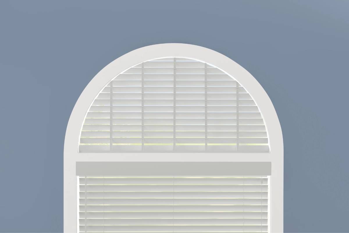 White Hunter Douglas Parkland® Wood Blinds hanging in an arched window