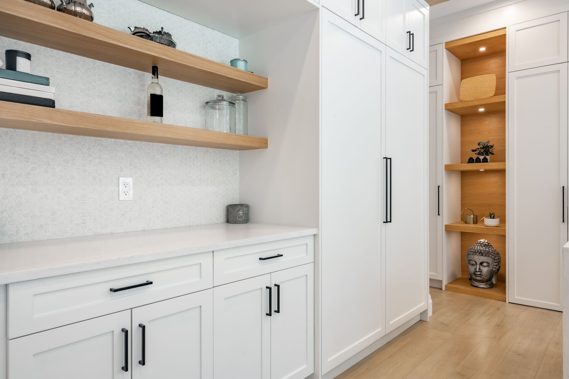 White kitchen cabinets, open shelves, with wood accents and decor.