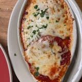 A close up of a pizza on a plate on a table.