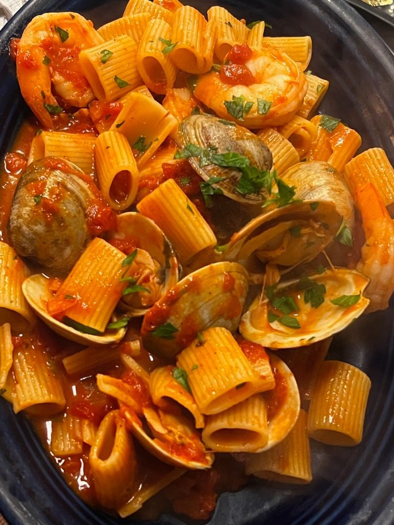 A close up of a pasta dish with clams and shrimp