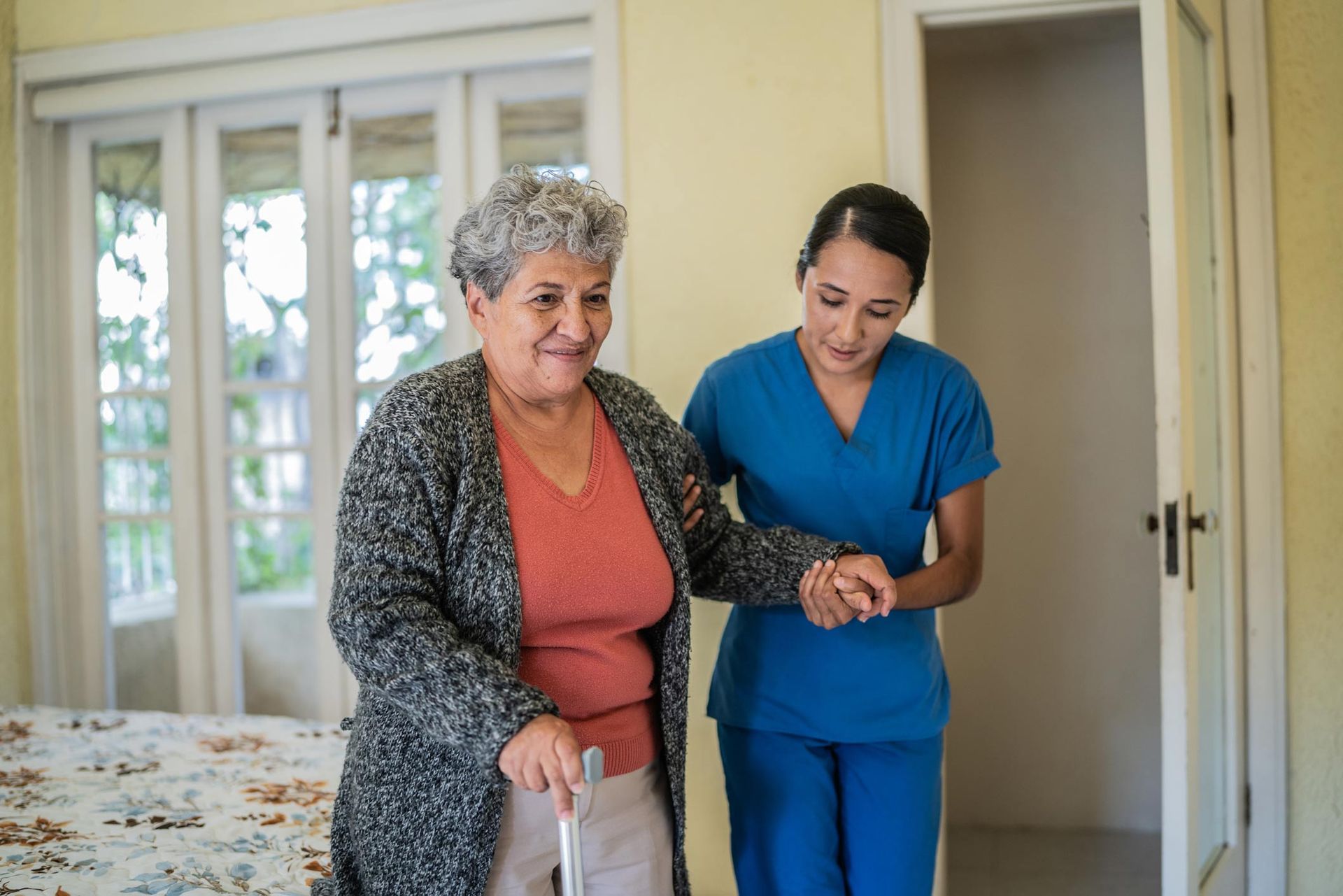 Nurse helping a senior woman walk | Joliet, IL | Friends over Fifty Senior Care