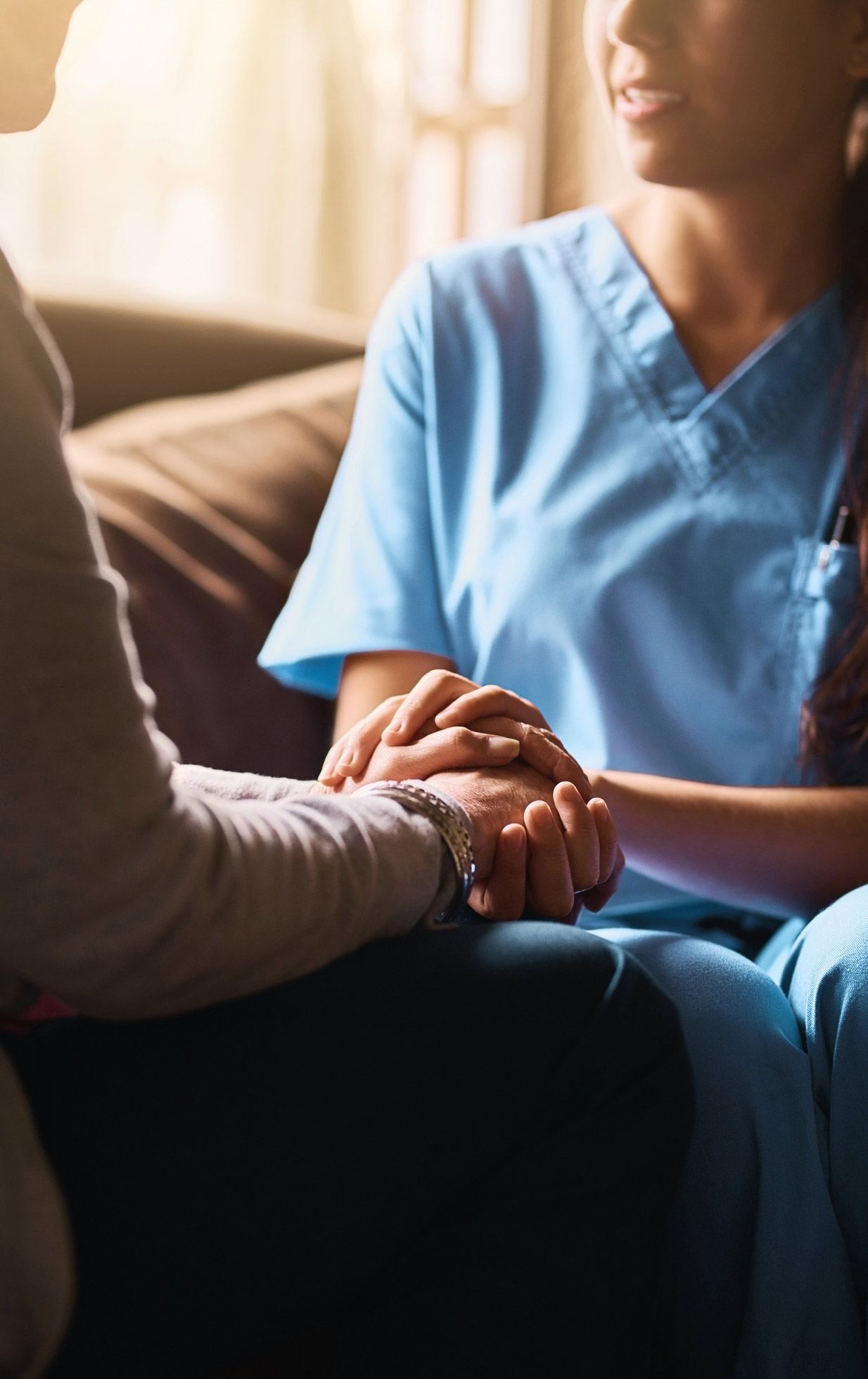 Nurse holding a senior woman's hands | Joliet, IL | Friends over Fifty Senior Care