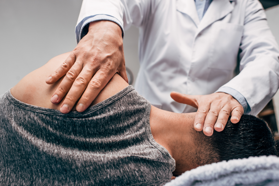 A man is getting a massage from a doctor.