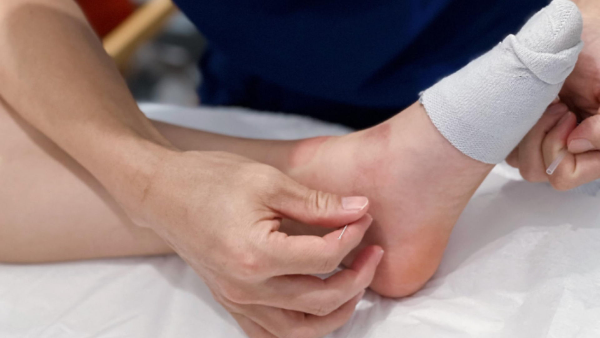 A person is getting a foot massage on a bed.
