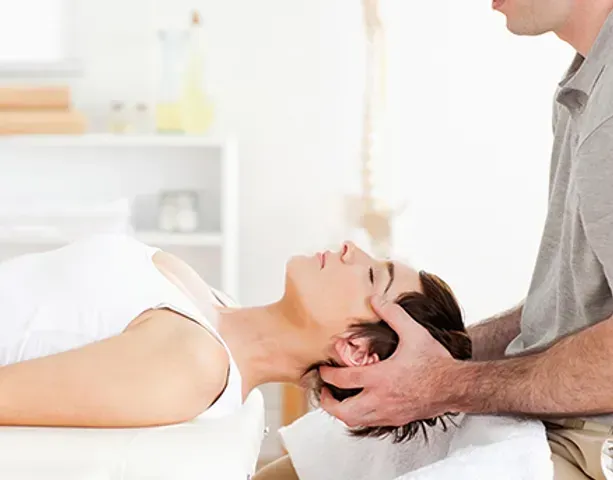 A woman is getting acupuncture on her shoulder.