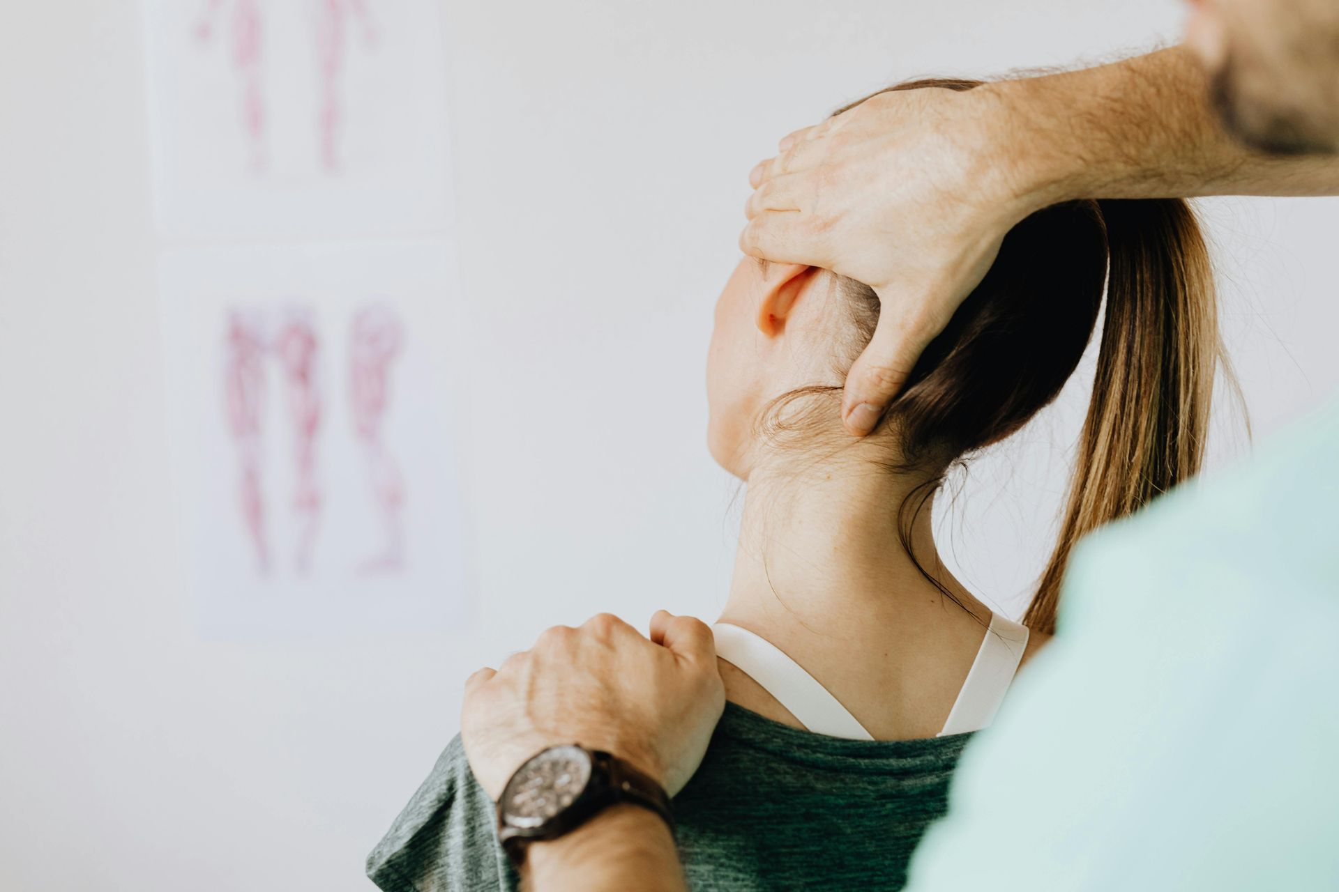 A man is giving a woman a massage on her neck.