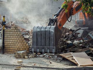 A Bulldozer Is Demolishing a Brick Building  | Independence, KS | K & M Pasture Clearing and Skid Loader Services