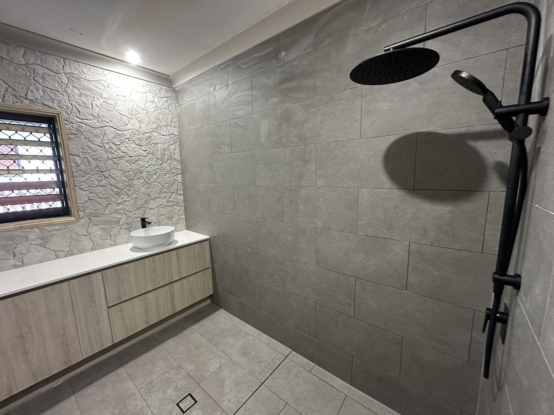 A Large Building With A Lot Of Tanks In Front Of It — Northern Plumbing In Mount Louisa, QLD