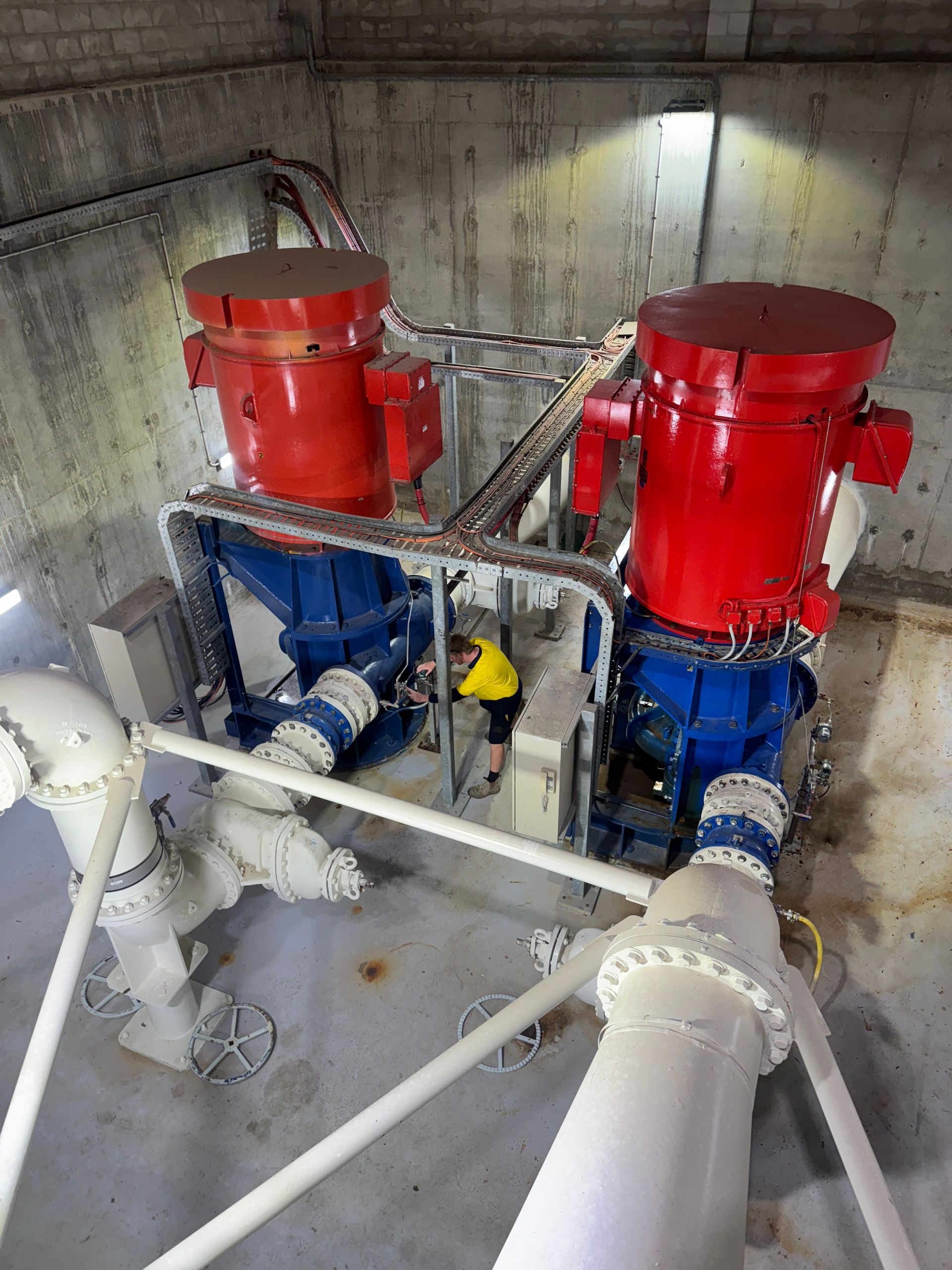 Two Large Red and Blue Industrial Machines With Pipes — Northern Plumbing In Bushland Beach, QLD