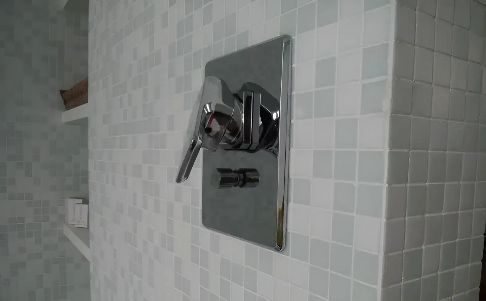 A Close Up Of A Shower Head On A Tiled Wall In A Bathroom — Northern Plumbing In Mount Louisa, QLD