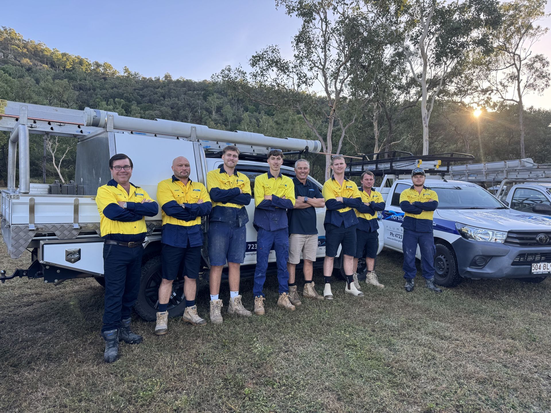 A Group Of Men Are Posing For A Picture In Front Of A Truck — Northern Plumbing In Mount Louisa, QLD