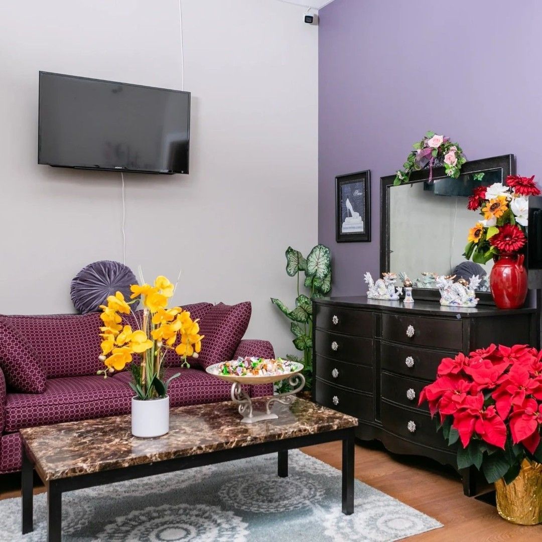 A living room with a purple couch and a coffee table