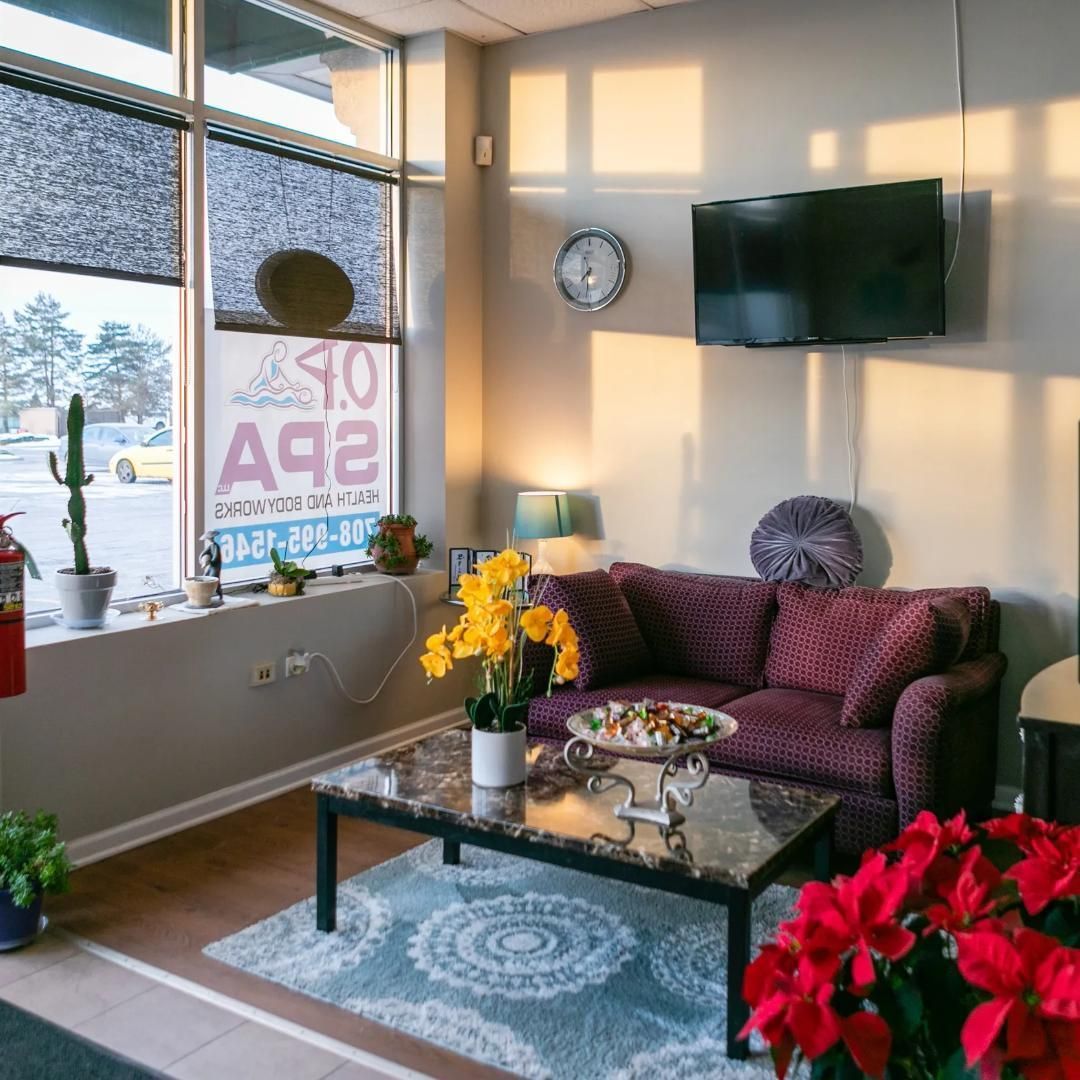 A living room with a purple couch and a coffee table