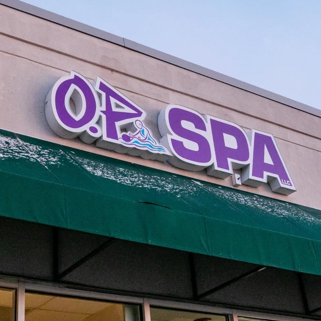 The outside of a spa with a green awning
