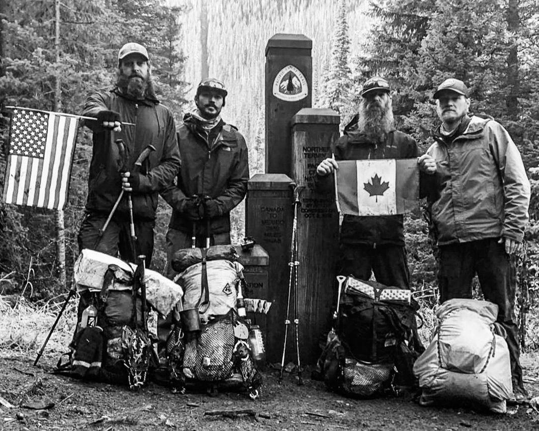 A group of men standing next to each other holding flags.