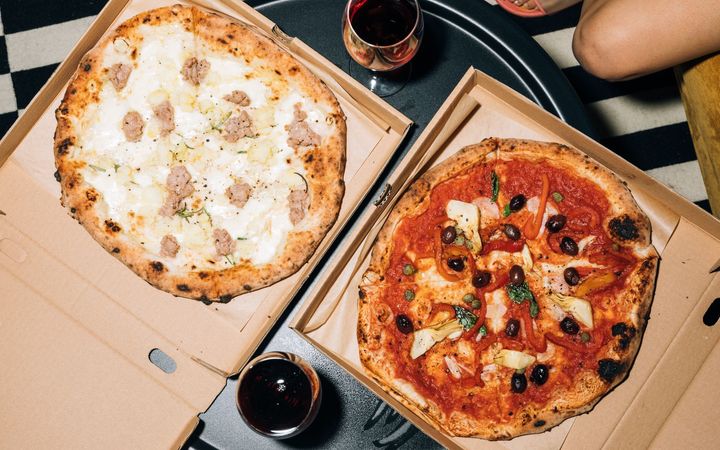 A photo of pizza in a box delivered by Rudy's Pizza in Newark, DE