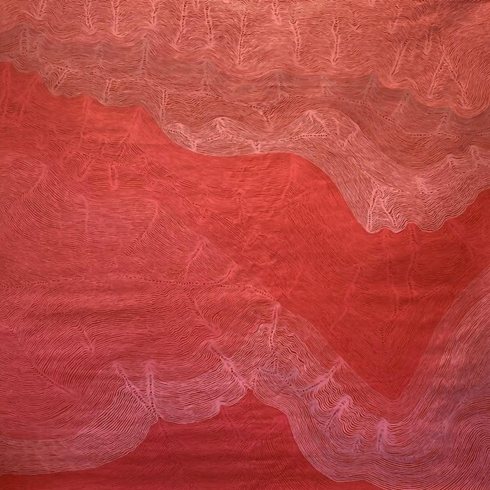 A close up of a red and white painting on a wall.