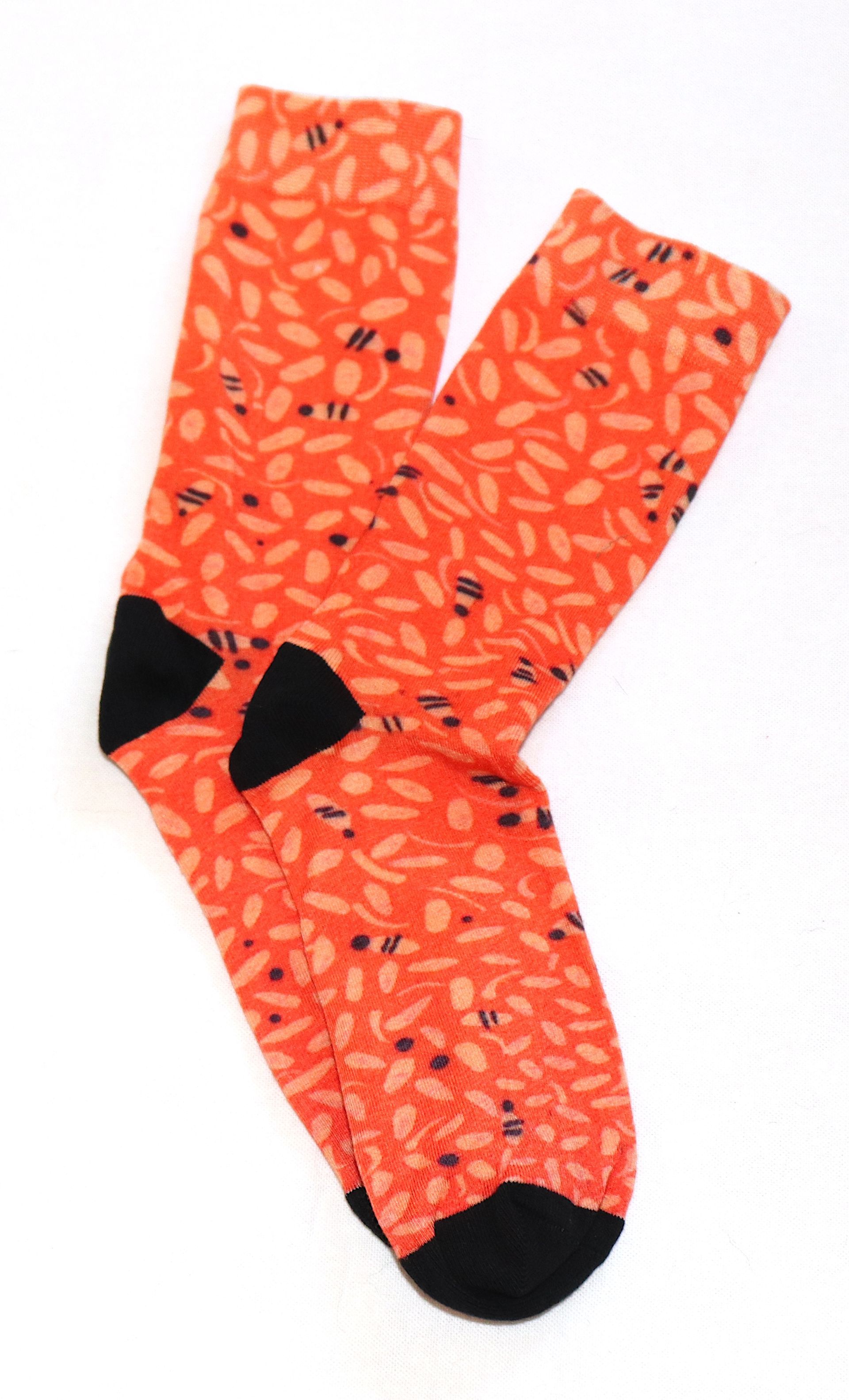 A pair of orange socks with black toes on a white background