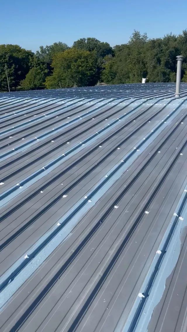 Professional commercial metal roofing installation on a large multi-level building in Middleton WI.