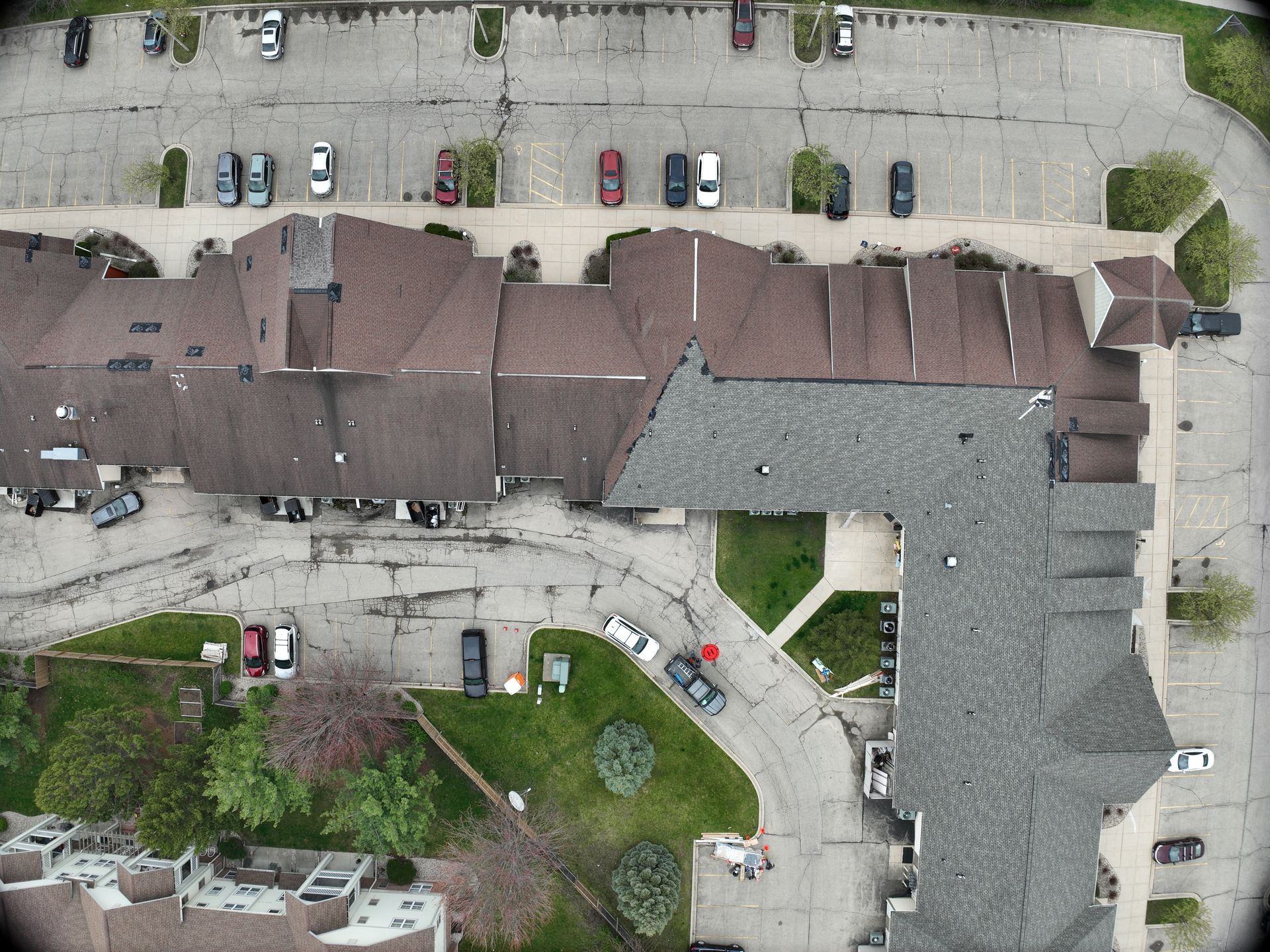 Aerial view of a professional roof replacement project for a large building in Middleton.