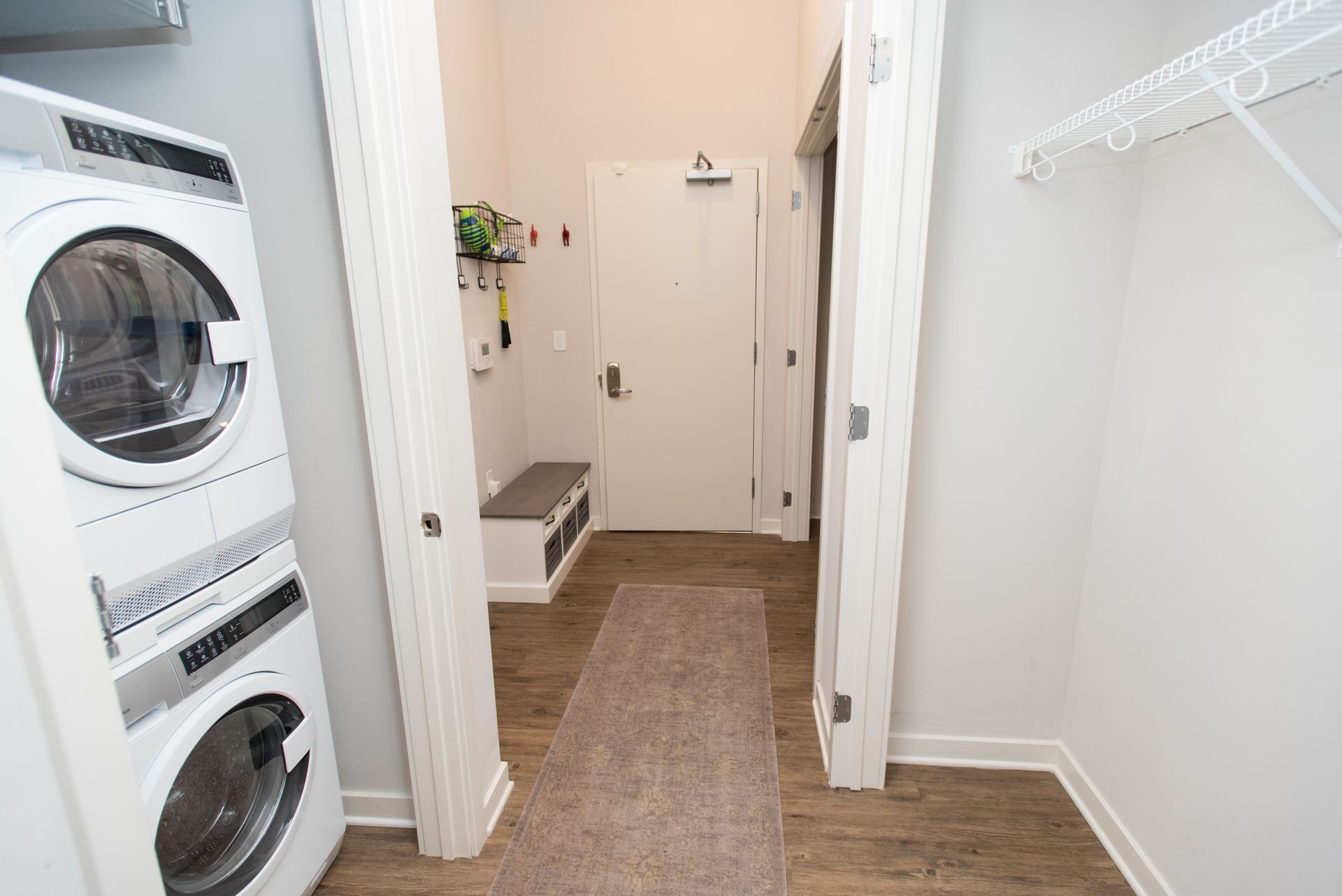 A laundry room with a washer and dryer stacked on top of each other.