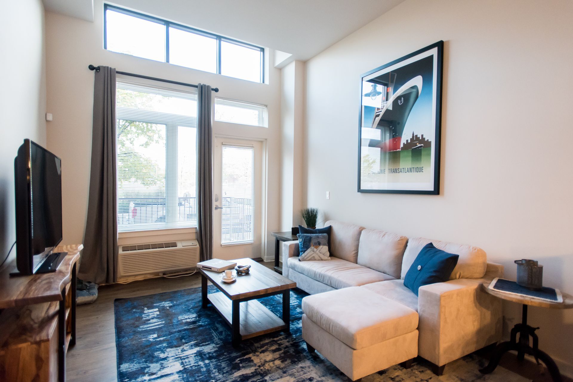 A living room with a couch , coffee table , and television.