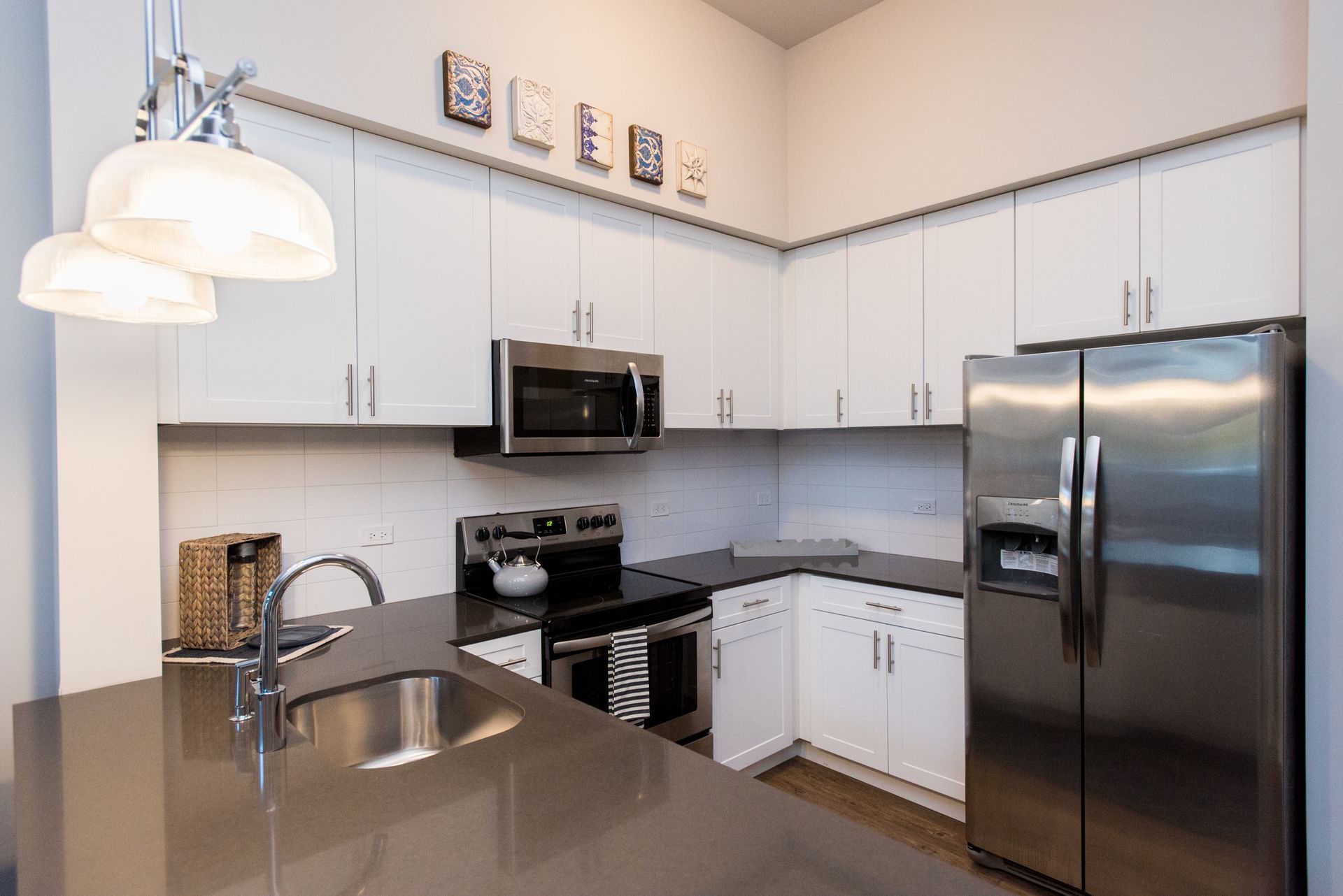 A kitchen with stainless steel appliances and white cabinets