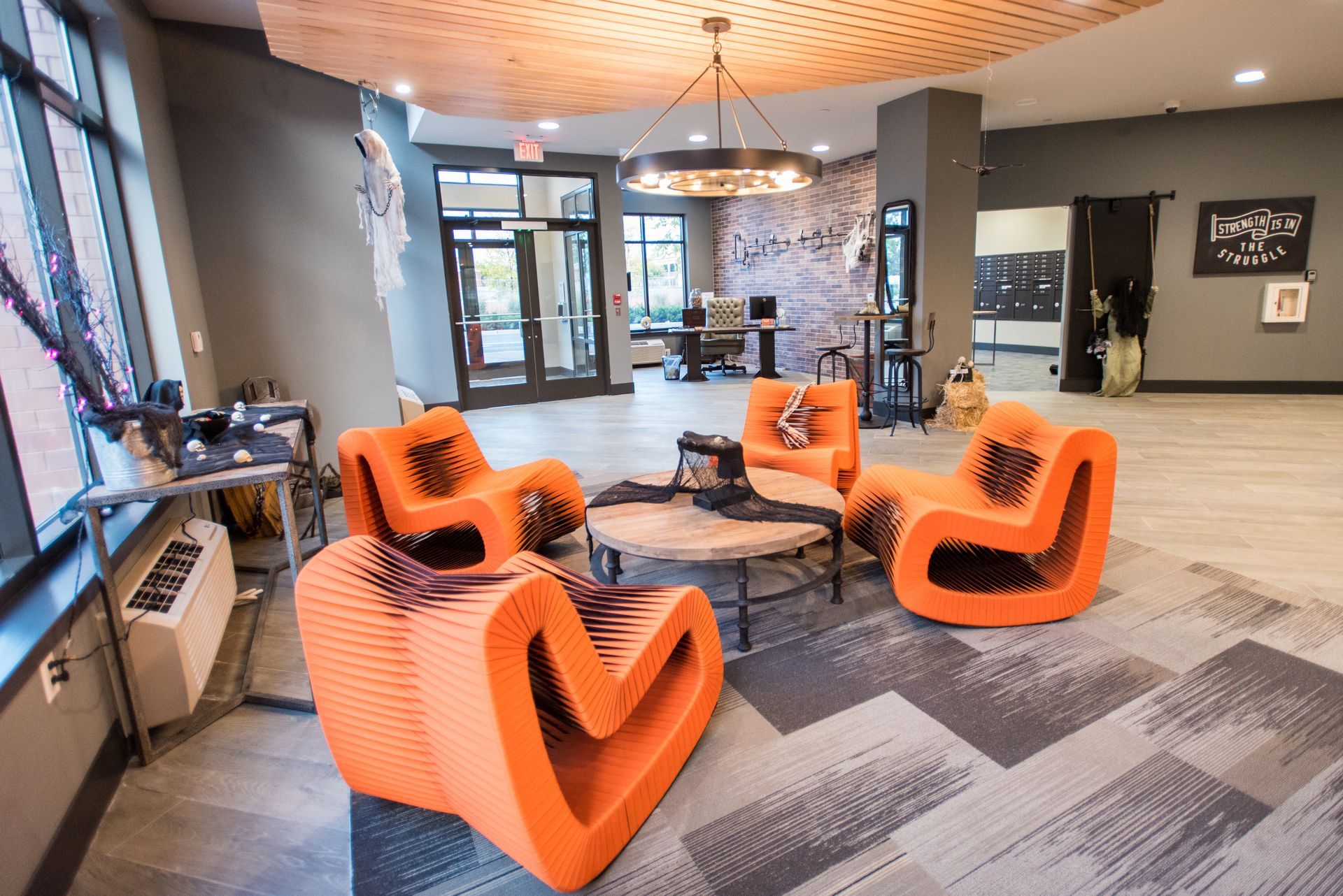 A living room with orange chairs and a table