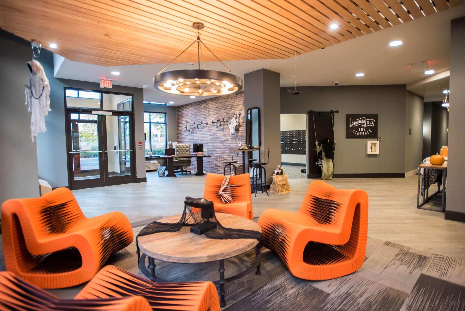 A living room with orange chairs and a coffee table