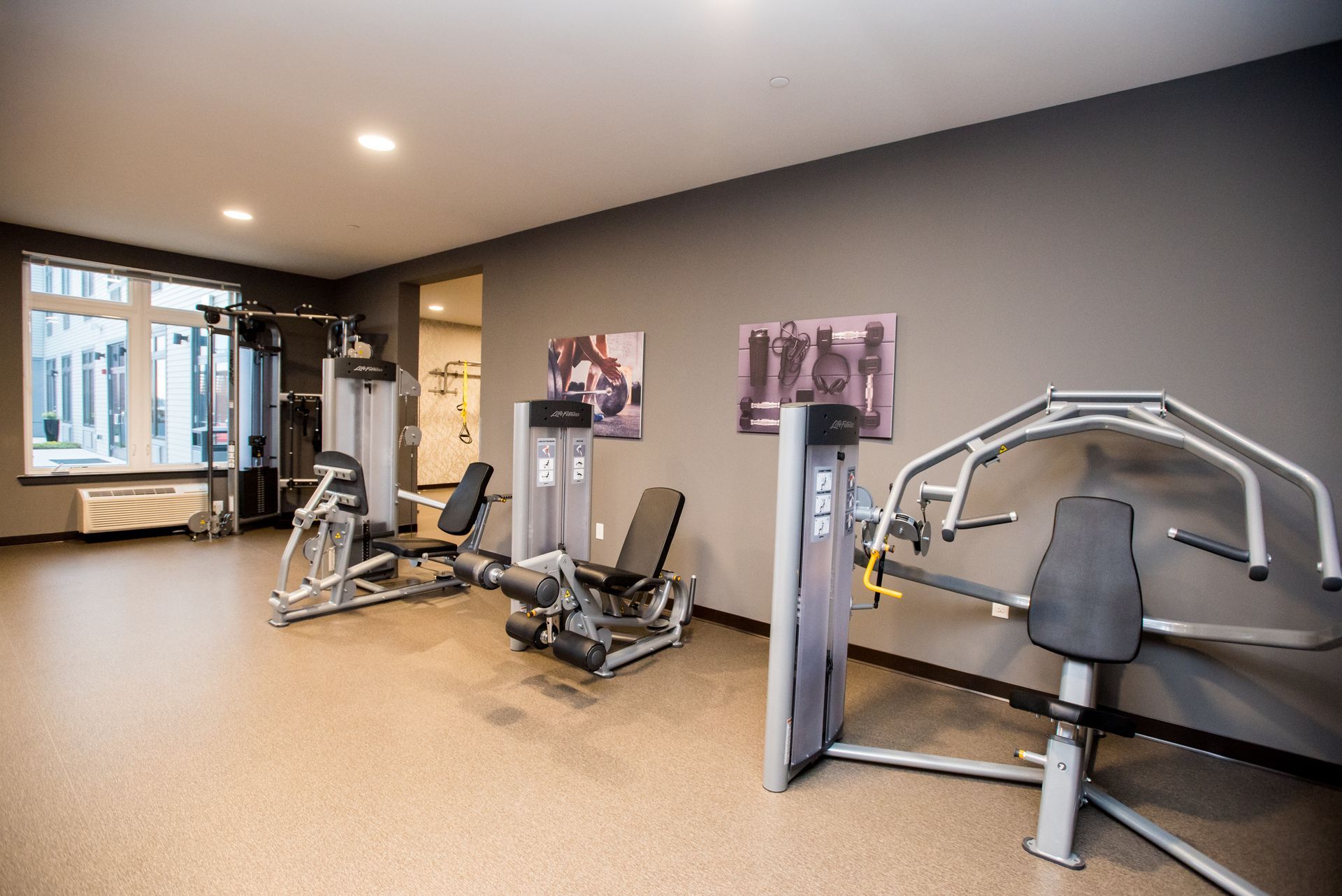 A gym with a lot of exercise equipment in it.