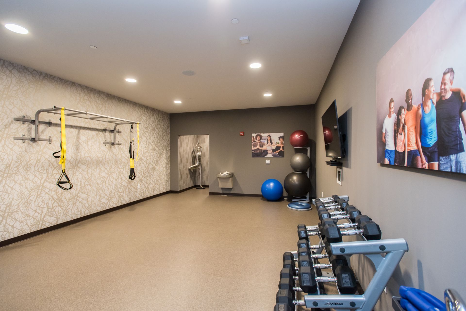 A gym with a picture of a group of people on the wall.