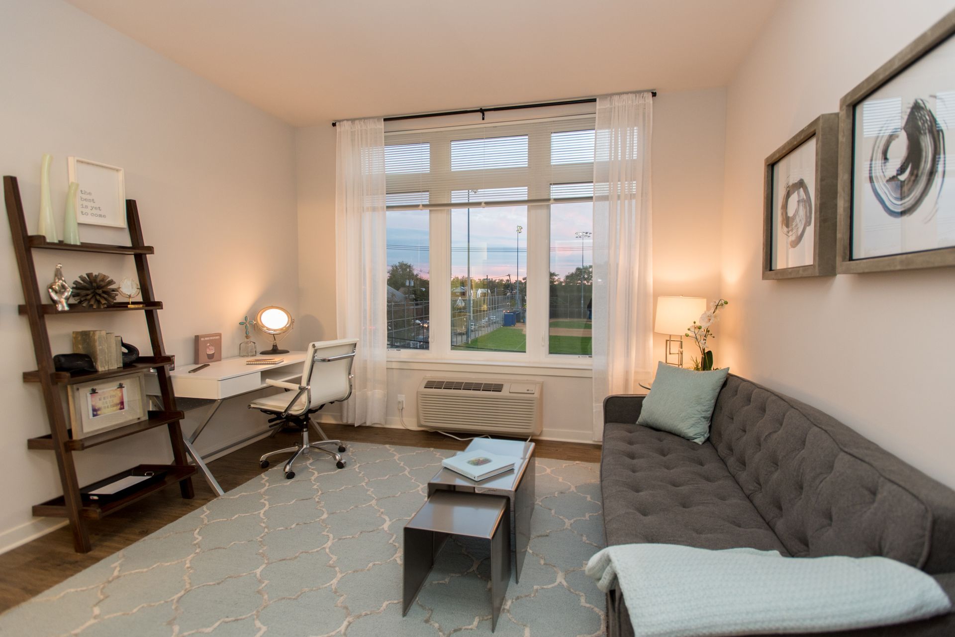 A living room with a couch and a desk