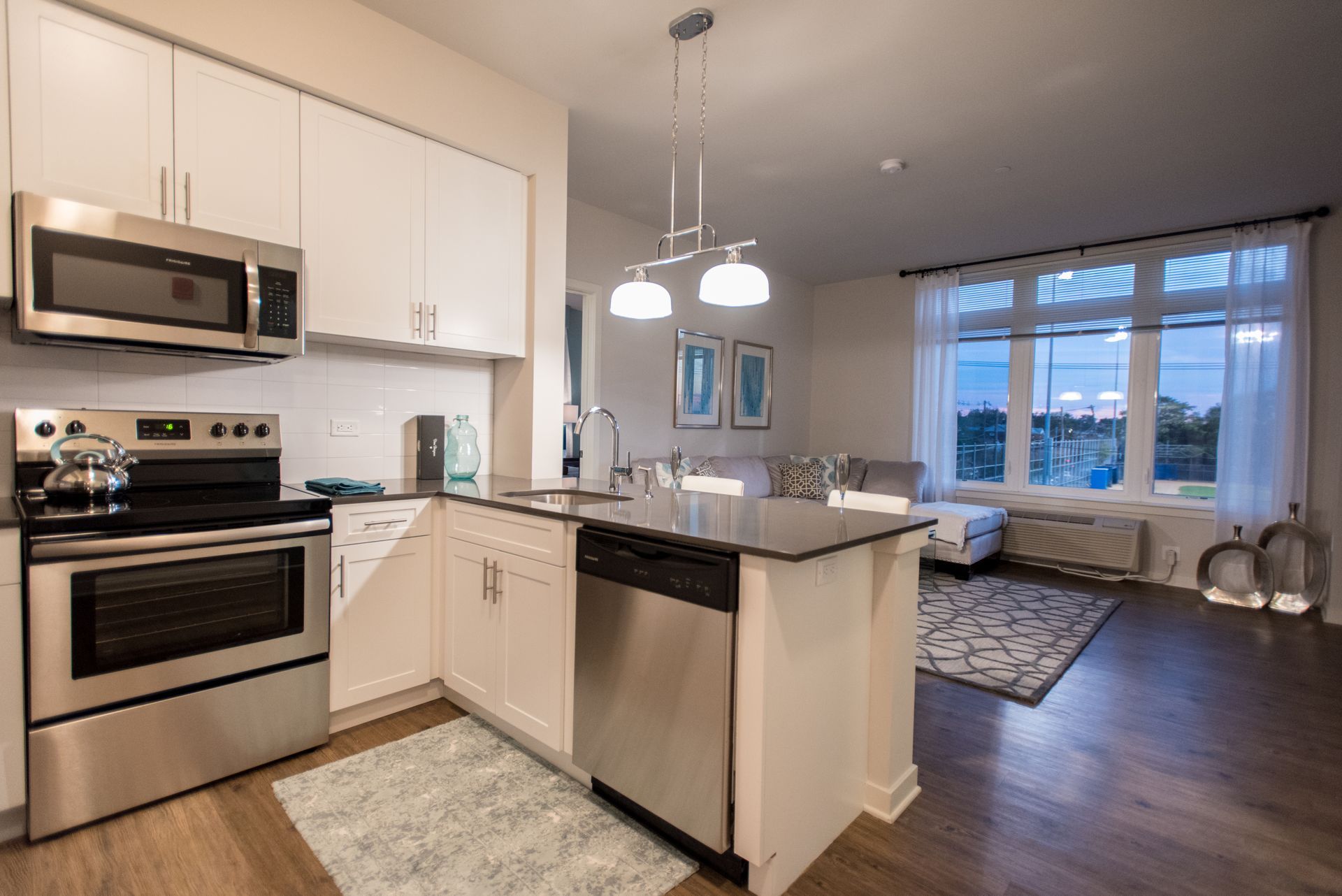 A kitchen with stainless steel appliances and white cabinets.