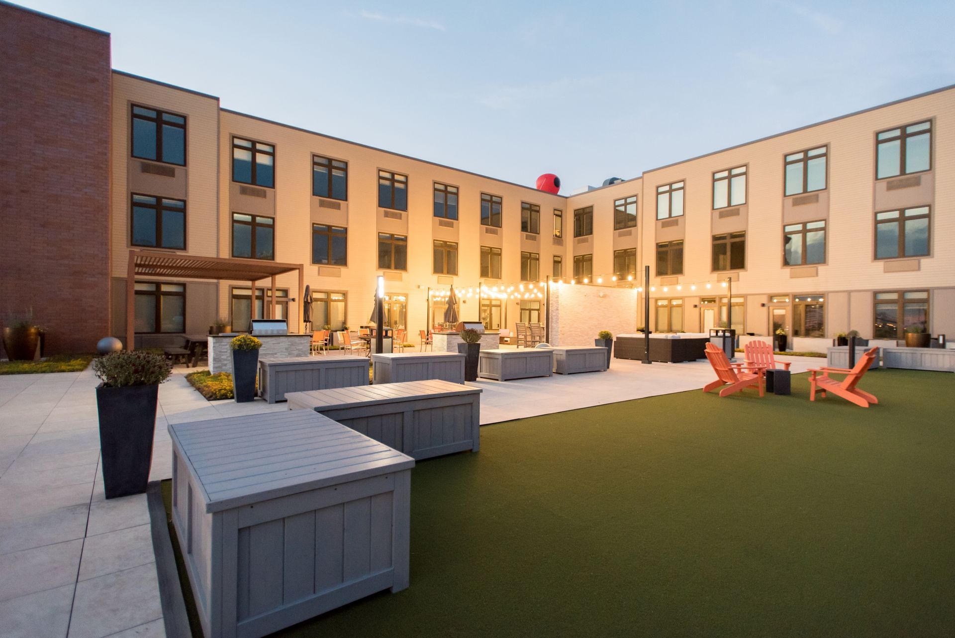 A large building with a lawn and chairs in front of it