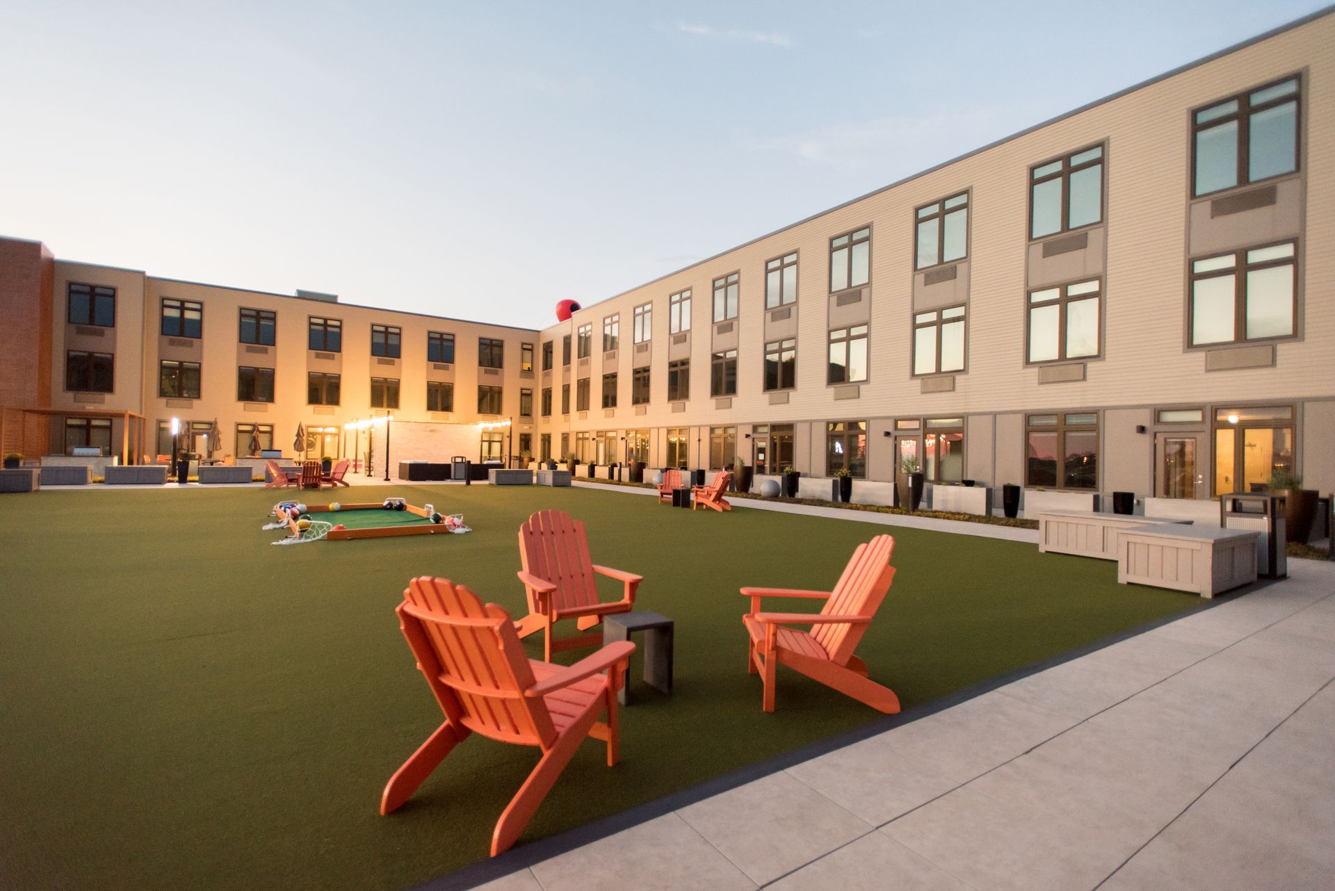 A large building with lawn chairs in front of it.