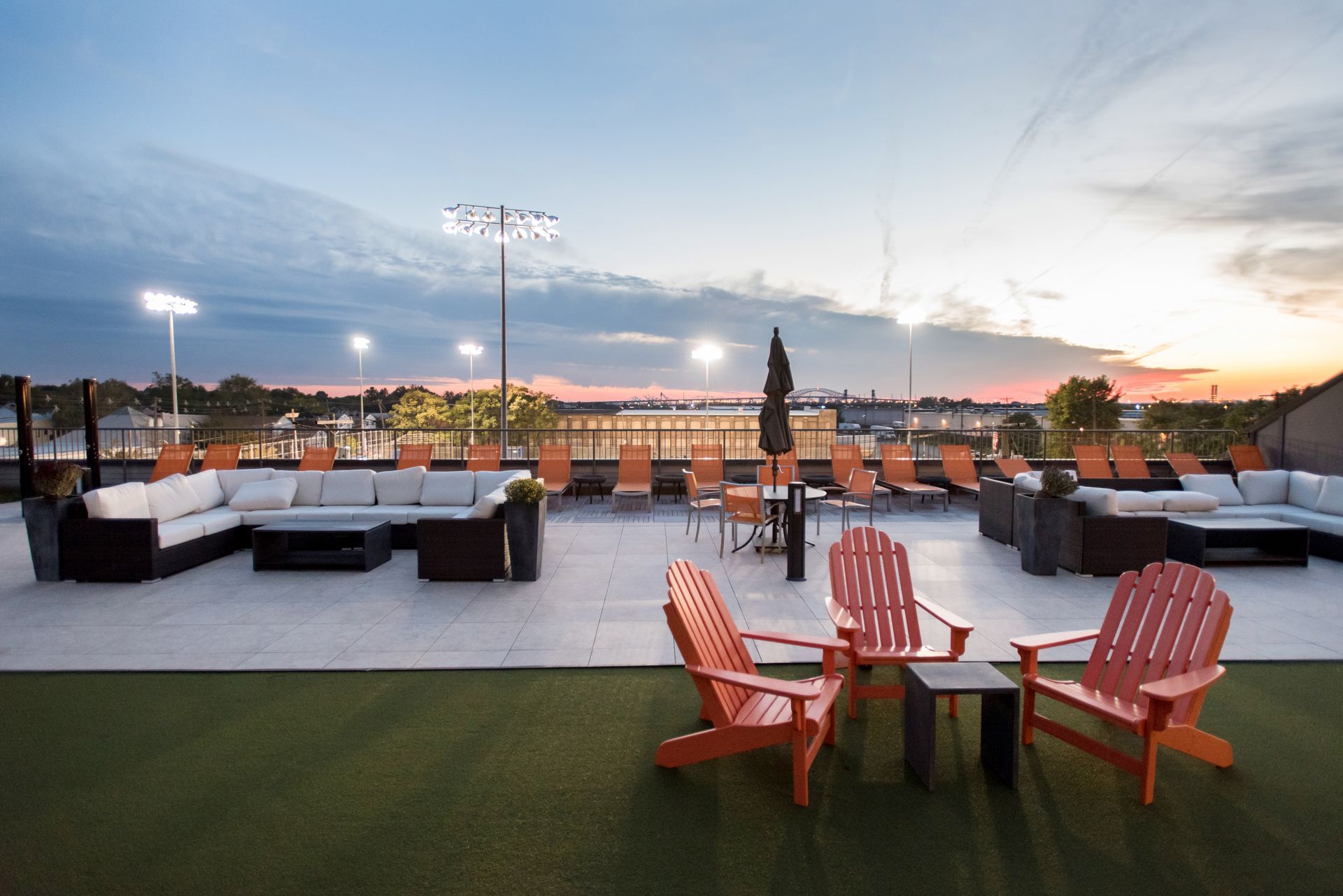 A rooftop patio with a lot of chairs and tables