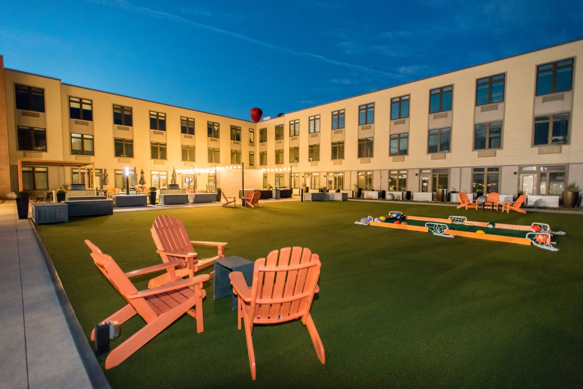 A large building with lawn chairs in front of it.