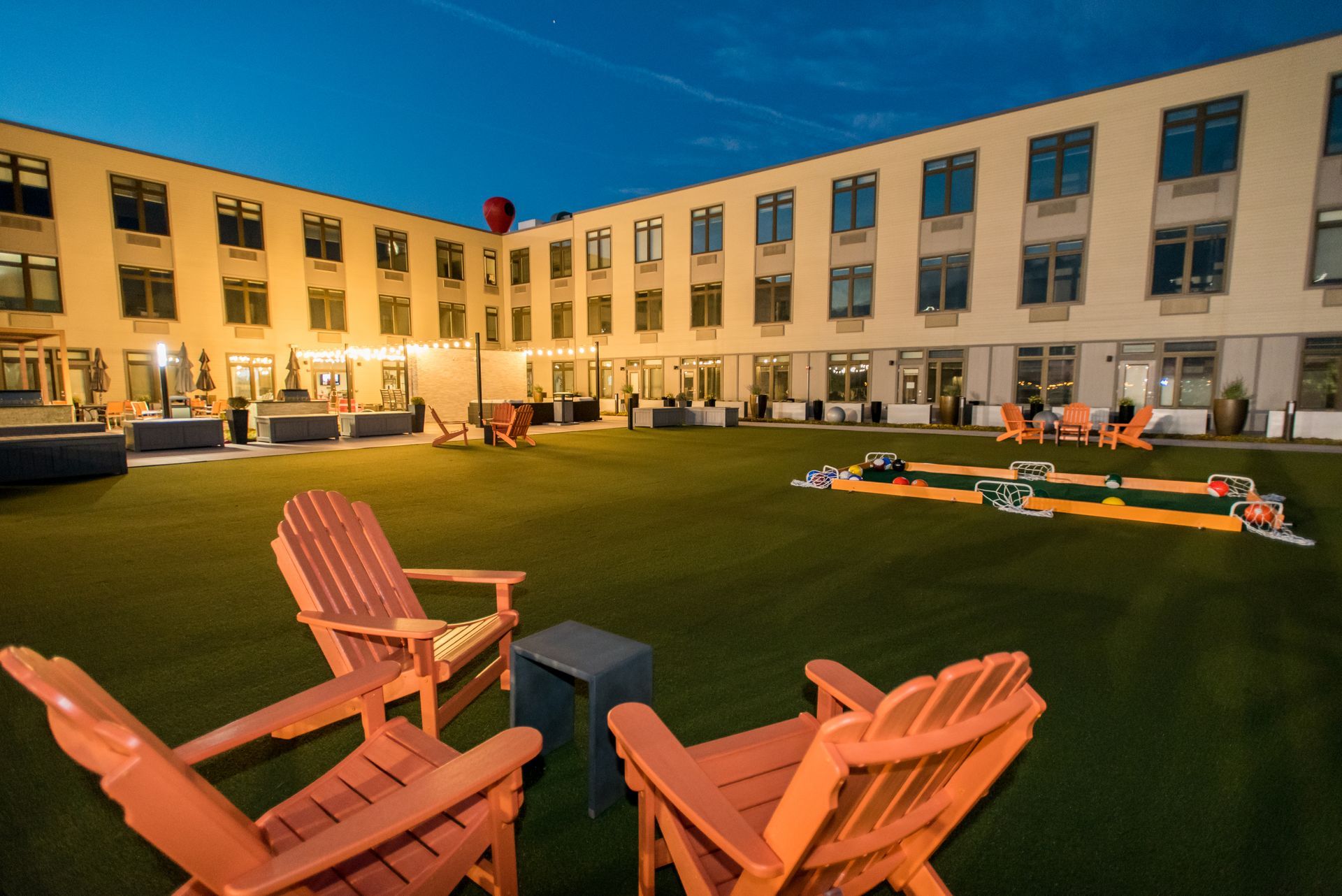 A large building with lawn chairs in front of it