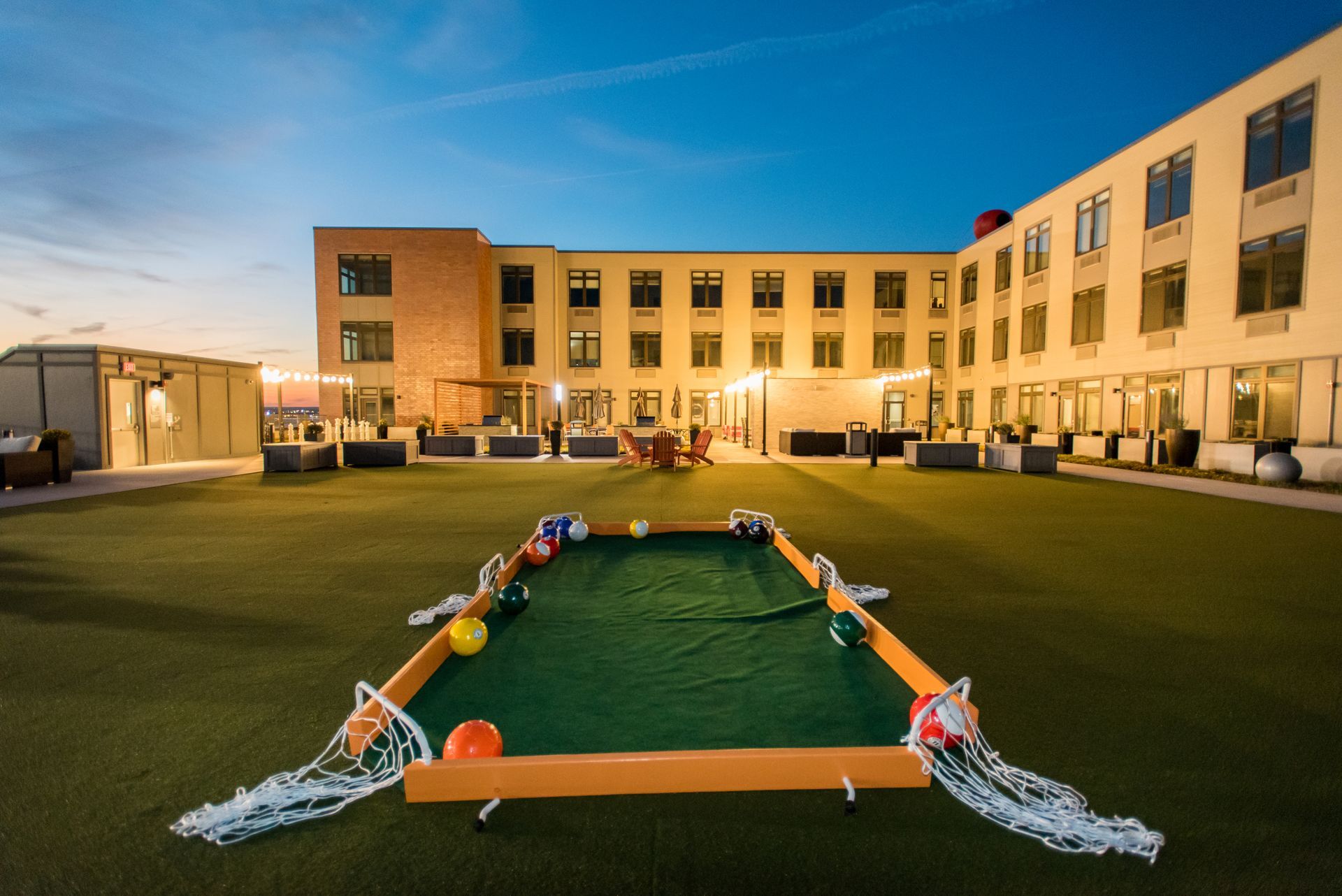 A large building with a pool table in front of it.