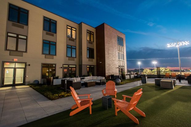 A group of chairs are sitting in front of a building.