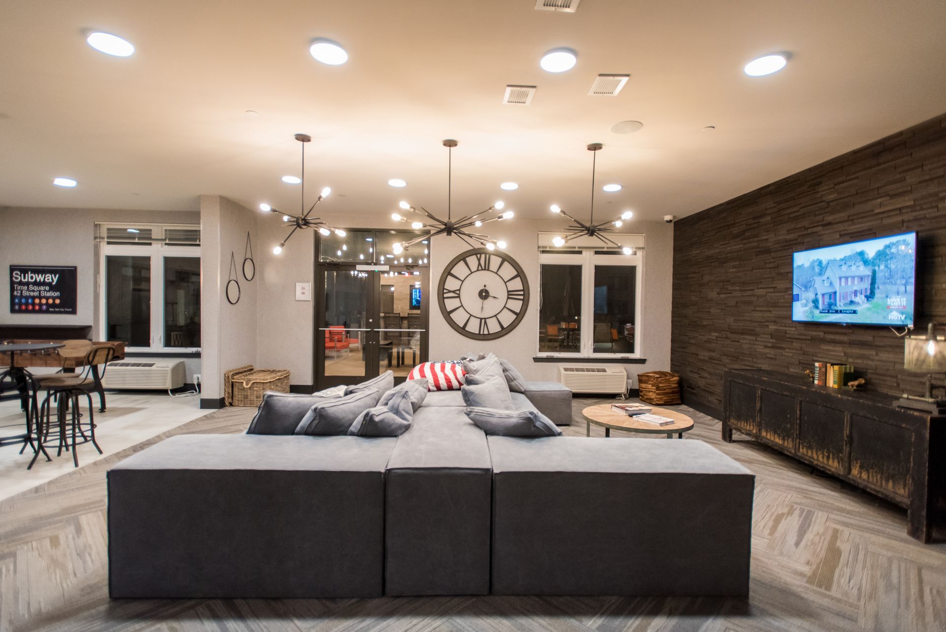 A living room with a large couch and a flat screen tv.